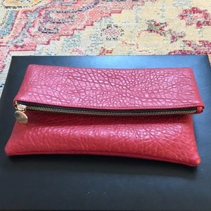 Red leather like fold over clutch